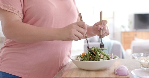 Woman Preparing Healthy Salad in Modern Kitchen