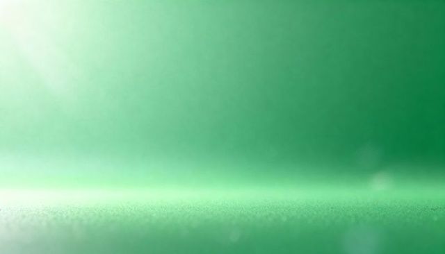 Emerald textured foreground meeting smooth gradient backdrop with soft bokeh flare