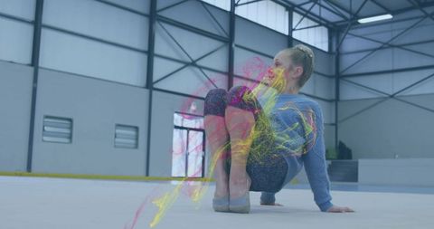 Child gymnast balancing in modern gym with neon color effects