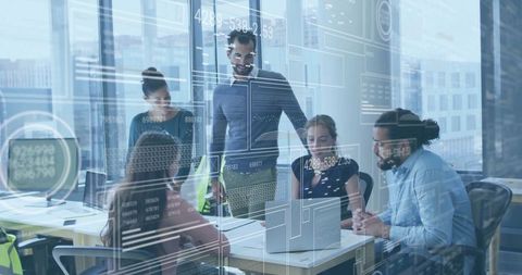 Modern Office: Team Analyzing Code on Laptops with Innovative Tech Overlays