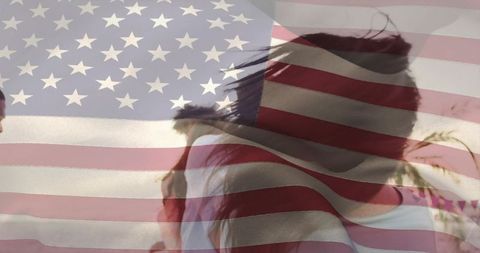 Facing away standing at rally with american flag overlay, patriotic silhouette, wind-blown hair