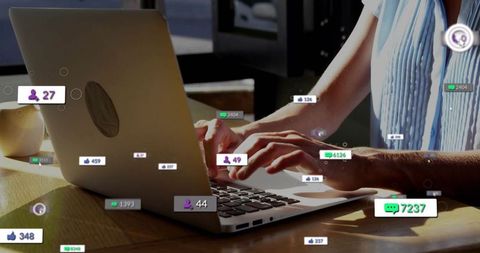 Woman typing on laptop with social media notifications overlay, remote work concept