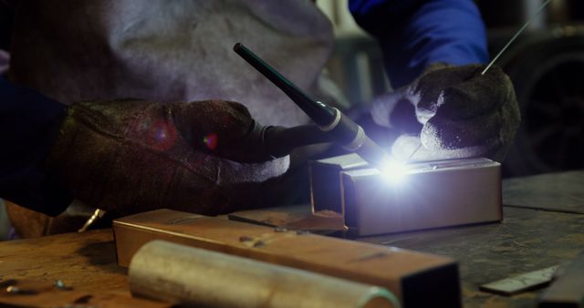 Welder Crafting Precision Metalwork in Dimly Lit Workshop - Download Free Stock Images Pikwizard.com