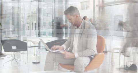 Busy Office with Professional Man Working on Laptop