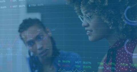 Diverse Colleagues Discussing Financial Data in Modern Workspace