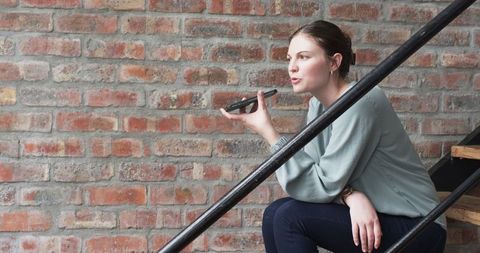 Young professional using voice command on smartphone