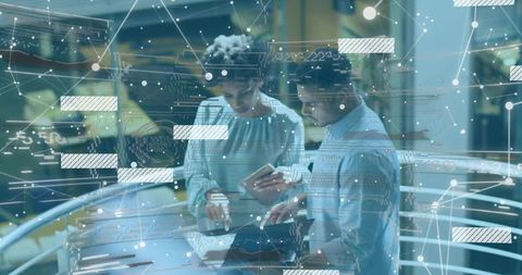 Professionals Collaborating Over Laptop in High-Tech Atrium with Digital Network Overlay
