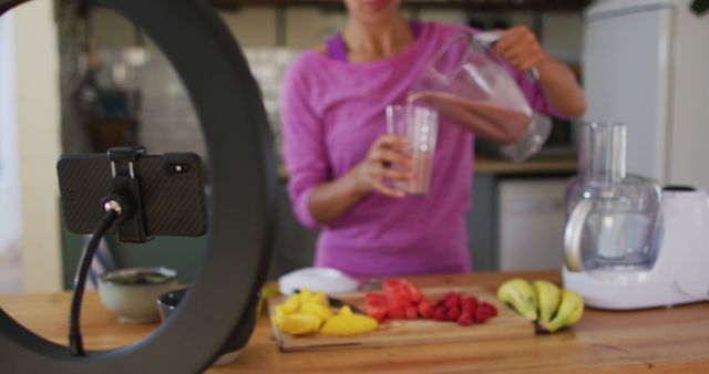 Female Blogger Pouring Smoothie Recording Vlog in Kitchen - Download Free Stock Images Pikwizard.com