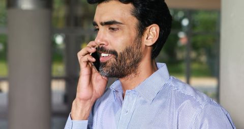 Middle-aged businessman on phone in serious conversation