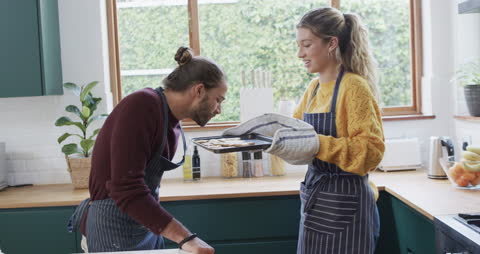 Happy Couple Baking Cookies Together at Home