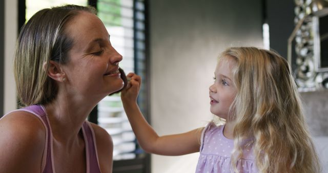 Mother and Daughter Sharing a Fun Moment with Makeup - Download Free Stock Images Pikwizard.com