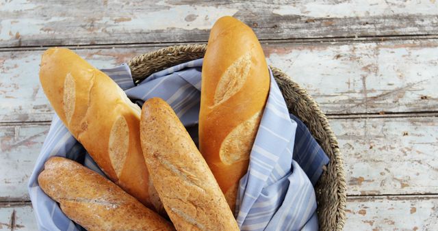 Freshly Baked Baguettes in Wicker Basket on Rustic Wooden Table - Download Free Stock Images Pikwizard.com