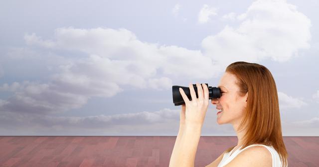 This image of a woman using binoculars against a cloudy sky backdrop can be utilized in travel blogs, exploration topics, advertisements for optical equipment, and motivational content about looking forward or searching for new opportunities.
