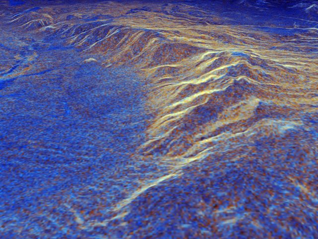 This digitally constructed 3D perspective view reveals the Long Valley caldera in California using data from the SIR-C/X-SAR radar on board space shuttle Endeavour. Captured with radar interferometry, the data maps the region's elevation on April 13, 1994 and October 3, 1994. Blue indicates smooth areas, while yellow highlights rocky outcrops with snow and vegetation, framing the landscape's geological activity. Ideal for studies on volcanic activity, geological transitions, or educational materials about orbital radar technology.