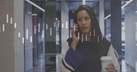 Businesswoman analyzing financial data on phone in modern office