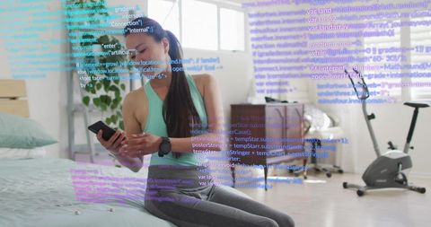 Woman checking smartphone and smartwatch in bedroom with code overlay