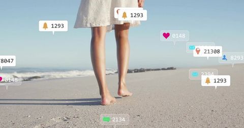 Person Walking Barefoot on Beach with Social Media Notifications