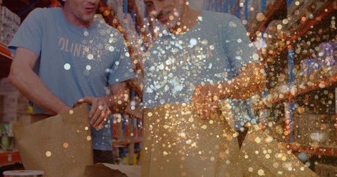 collaborative warehouse workers with festive glitter overlay - Download Free Stock Images Pikwizard.com