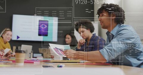 Diverse Team Analyzing Data in Modern Office Meeting