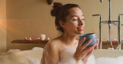 Woman Enjoying Coffee in Relaxing Bubble Bath Setting