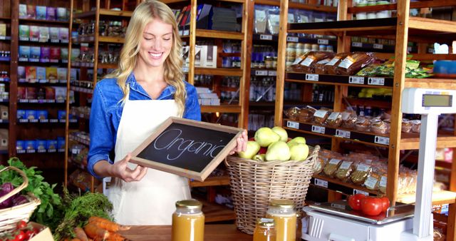 Smiling woman holding organic sign in market - Download Free Stock Images Pikwizard.com