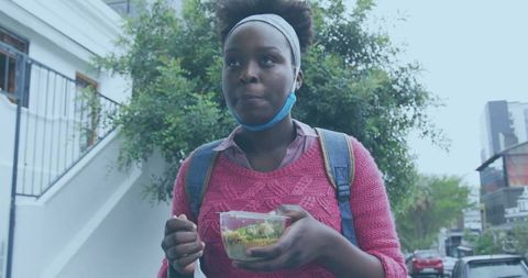 Urban Commuter Enjoying Healthy Snack on City Street