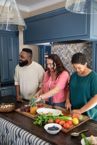 Diverse Friends Enjoying Healthy Cooking Together in Modern Kitchen