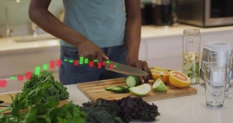 Woman slicing cucumber and fruits for smoothie with candlestick trading overlay