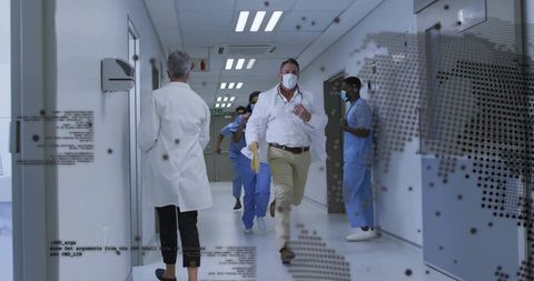 Hispanic doctor running through hospital corridor carrying urgent yellow medical folder