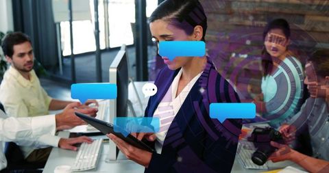 Businesswoman using tablet in modern coworking space with digital chat overlays and team