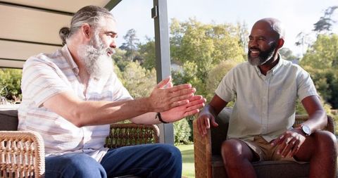Senior Friends Relaxing and Conversing on Patio