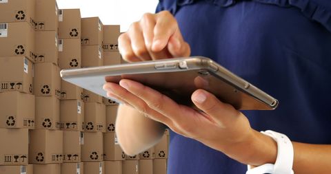 Using Tablet for Global Shipping Management with Stacked Boxes - Download Free Stock Images Pikwizard.com