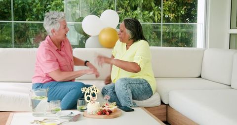 Senior Multicultural Lesbian Couple Joyfully Celebrating Birthday