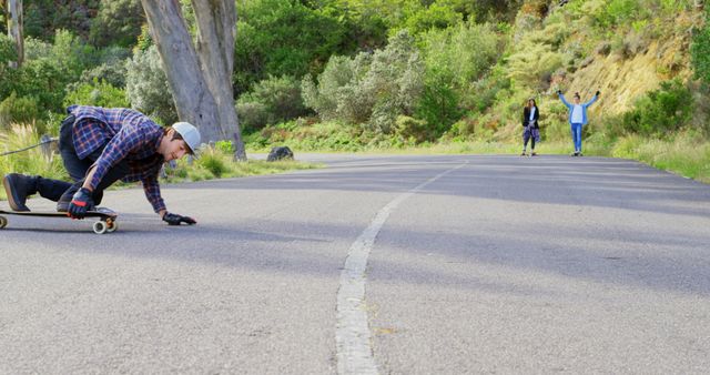 Young man enjoying longboarding on scenic road - Download Free Stock Images Pikwizard.com