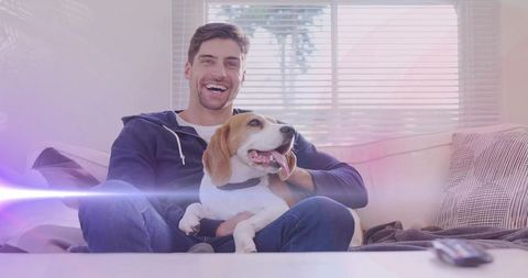 Man Enjoying Relaxing Time with Beagle Dog in Living Room