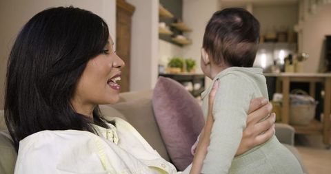 Mother with infant daughter enjoying quality time at home