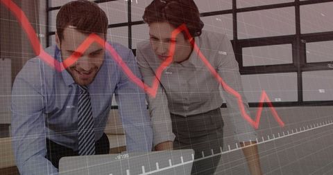 Business partners analyzing falling market trend on laptop with red decline graph overlay