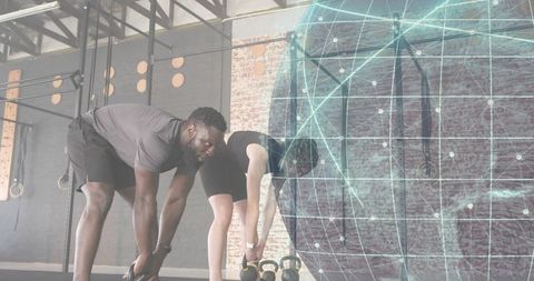 Trainer guiding woman during kettlebell reach in industrial gym with digital globe overlay