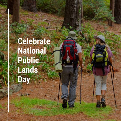 Couple trekking through forest on national public lands day