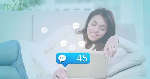 Smiling Woman Relaxing on Sofa with Tablet and Chat Notifications