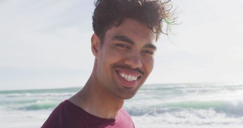 Happy Young Man Smiling by Ocean on Sunny Day - Download Free Stock Images Pikwizard.com