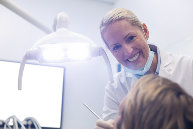 Transparent Smiling Dentist Examining Patient with Dental Tools - Download Free Stock Videos Pikwizard.com