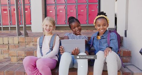 Diverse Schoolgirls Bonding with Tablet on School Steps