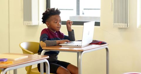 Young Student Studying on Laptop in Classroom Environment