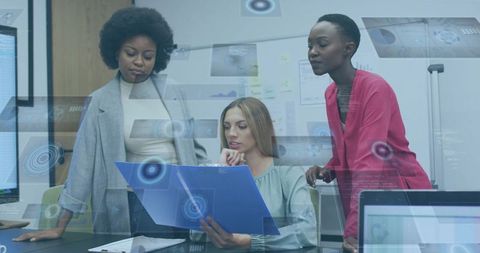 Multiracial professionals collaborating over analytics folder in modern office meeting
