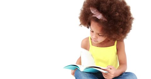 Curious Preschool Girl Enjoying Engaging Reading Time