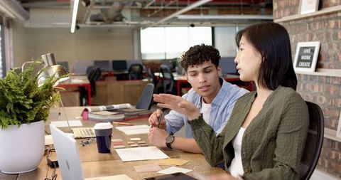 Diverse Coworkers Collaborating in Creative Modern Workspace