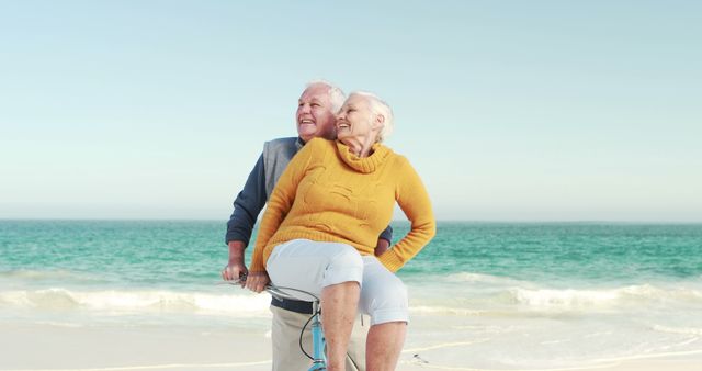 Happy Senior Couple Enjoying Bicycle Ride on Beach - Download Free Stock Images Pikwizard.com