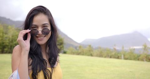 Smiling Woman in Sunglasses Enjoying Nature