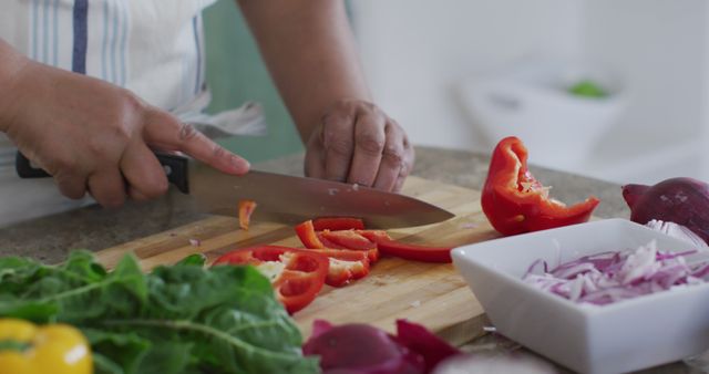 Close-Up of Person Chopping Red Bell Pepper in Kitchen - Download Free Stock Images Pikwizard.com